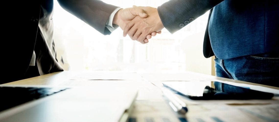 Businessmen shaking hands during a meeting.